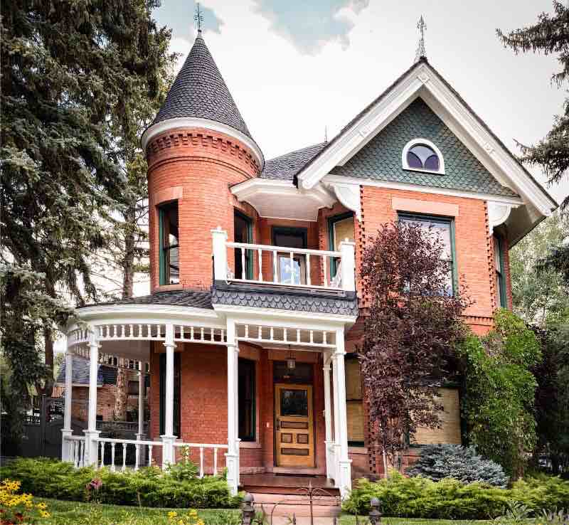 Victorian style home with curved front porch.