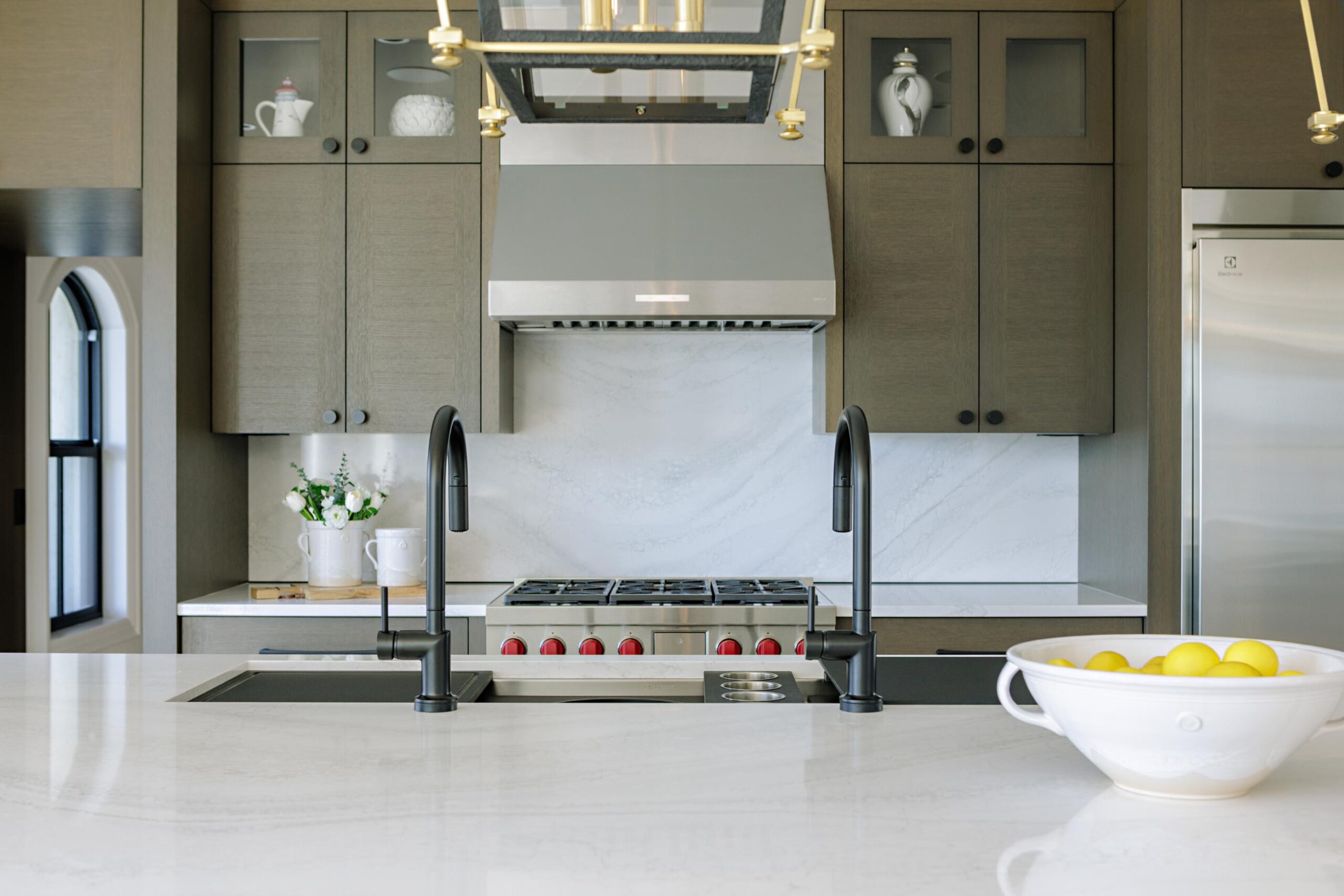 3-Generations-2023 Kitchen island with retractable stone backsplash open, dual faucets and brass lantern pendants