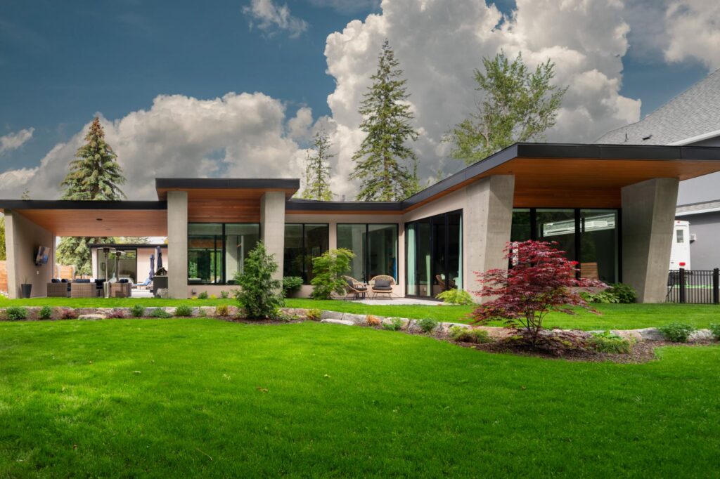 Single-level modern rancher with concrete pillars, cedar soffits and Japanese maple