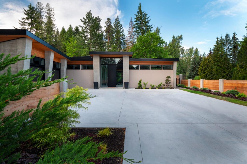 Creekside Rancher front entry with concrete pillars, cedar soffits and bonsai landscaping