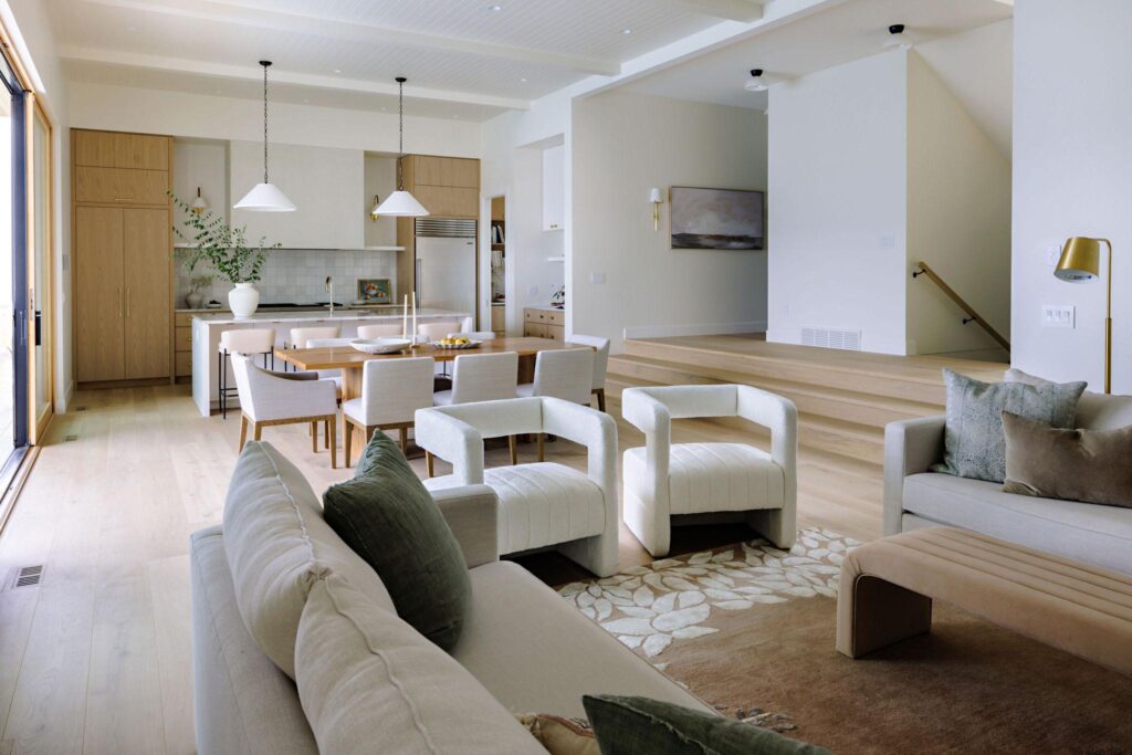 Living room with cream seating, oak kitchen beyond and split-level transition